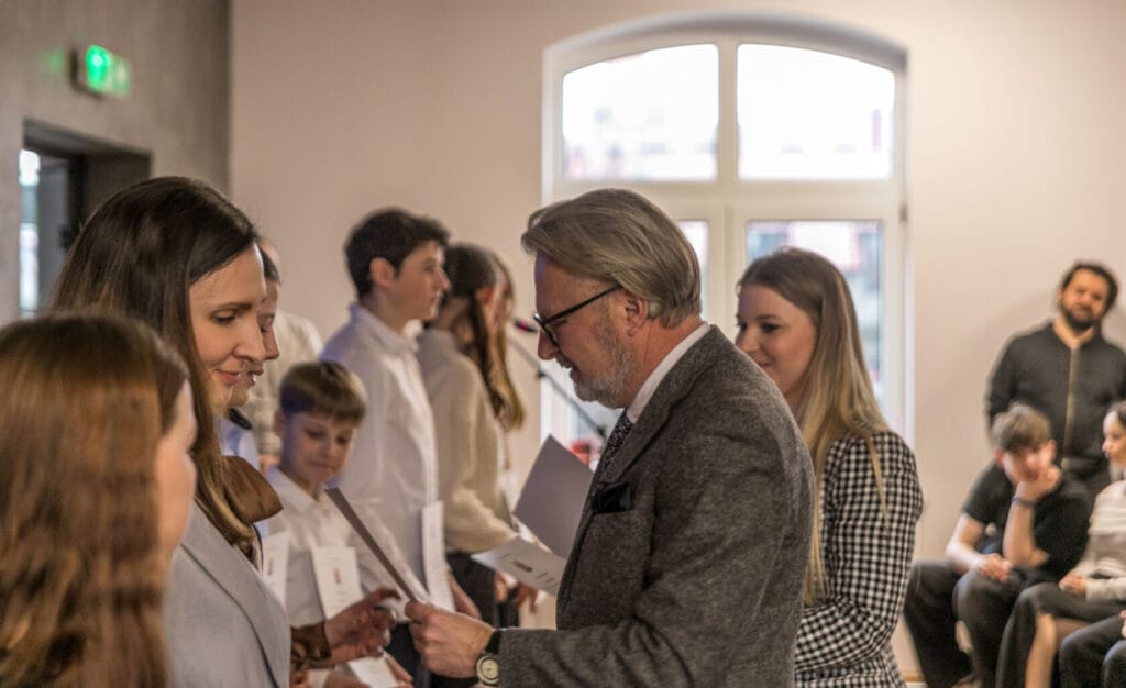 Starszy mężczyzna rozmawia z kobietą na seminarium